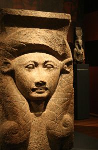 Hathor's head on an antique statue