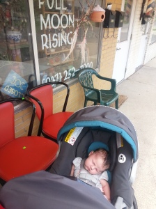 Sleeping baby in front of store window